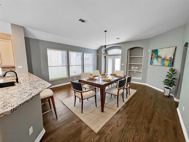 dining area with built in features, dark hardwood / wood-style floors, french doors, and sink