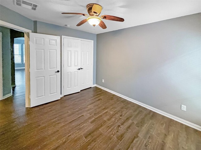 unfurnished bedroom with a closet, ceiling fan, and dark hardwood / wood-style floors