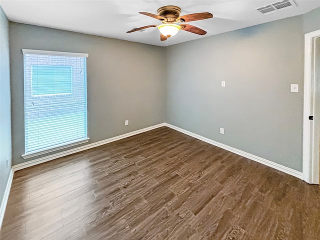 spare room featuring ceiling fan and dark hardwood / wood-style flooring