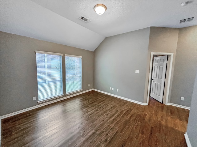 interior space featuring lofted ceiling and dark wood-type flooring