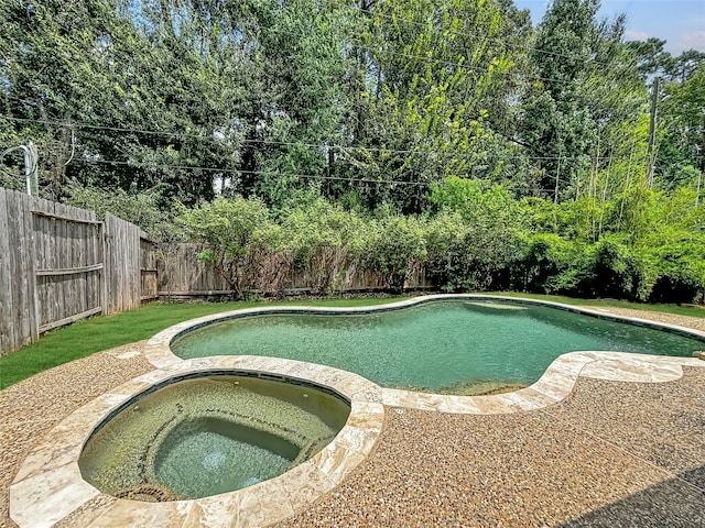 view of pool with an in ground hot tub