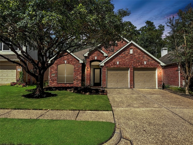 front of property with a garage and a yard