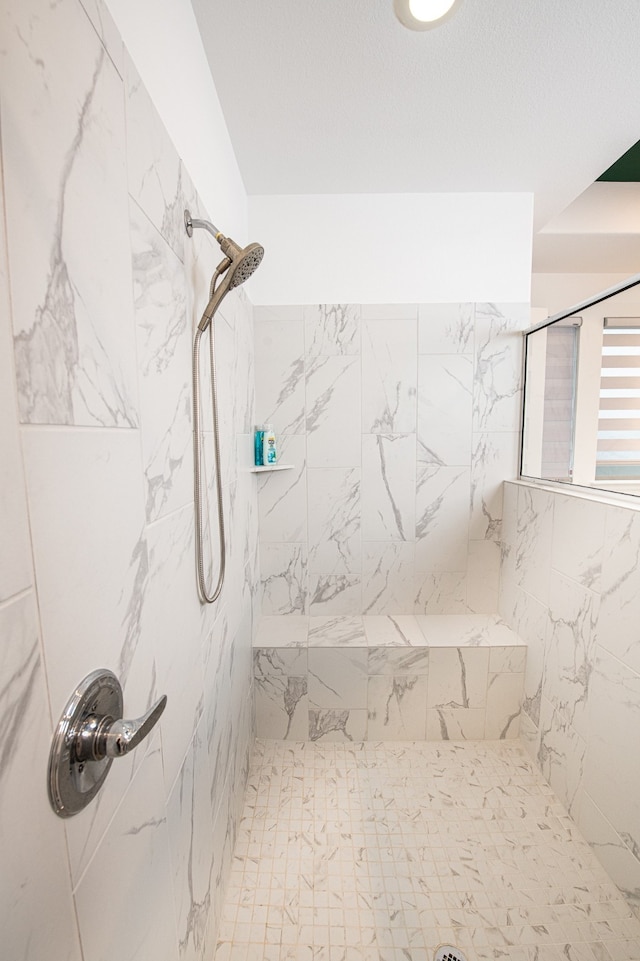 bathroom with tiled shower