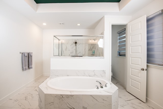 bathroom with separate shower and tub