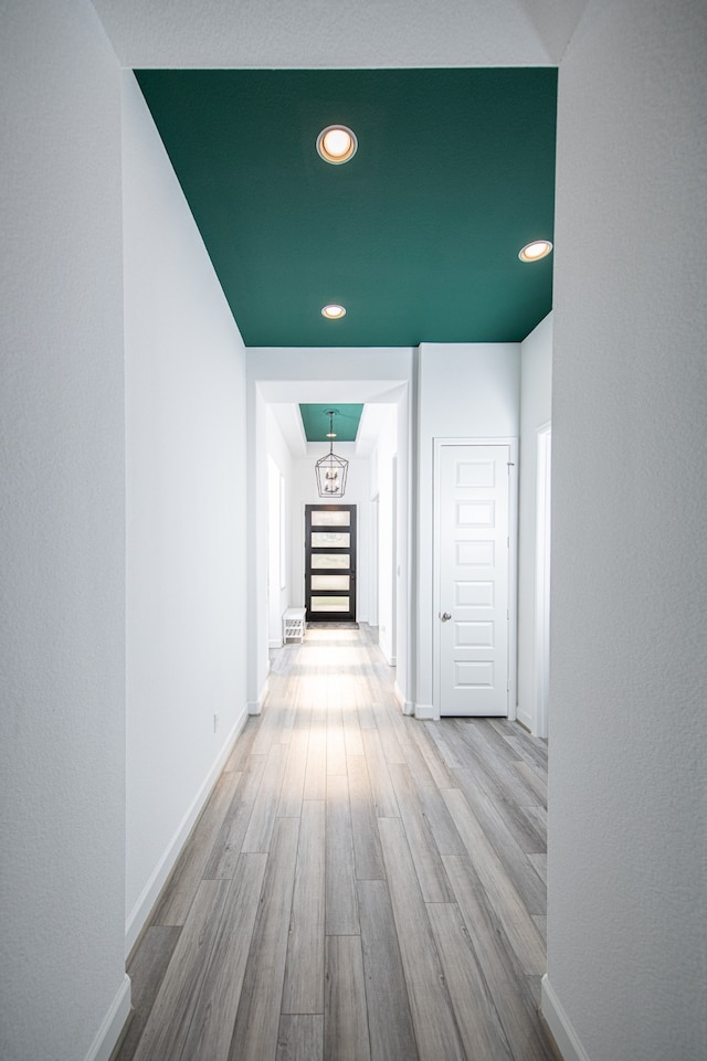 hallway with light hardwood / wood-style floors