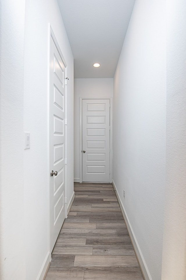 hallway with hardwood / wood-style floors