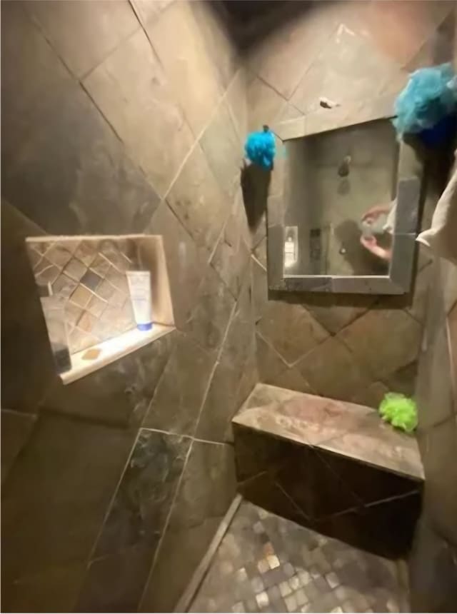 bathroom with tile walls