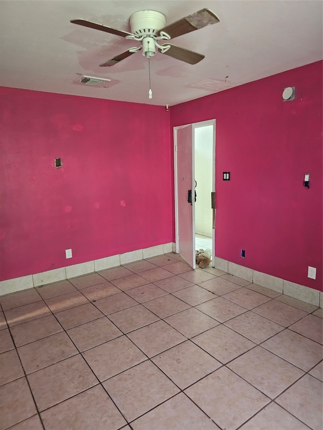 tiled spare room with ceiling fan