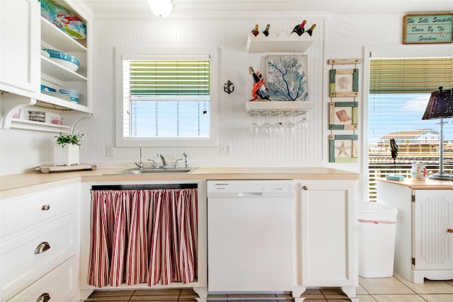 kitchen with dishwasher, light tile patterned floors, sink, and plenty of natural light