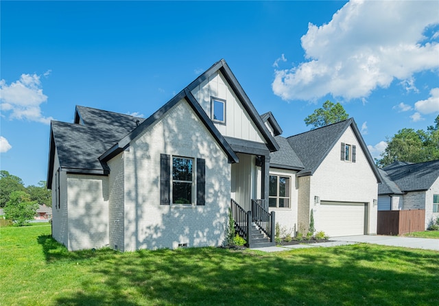 view of front of house with a front yard and a garage