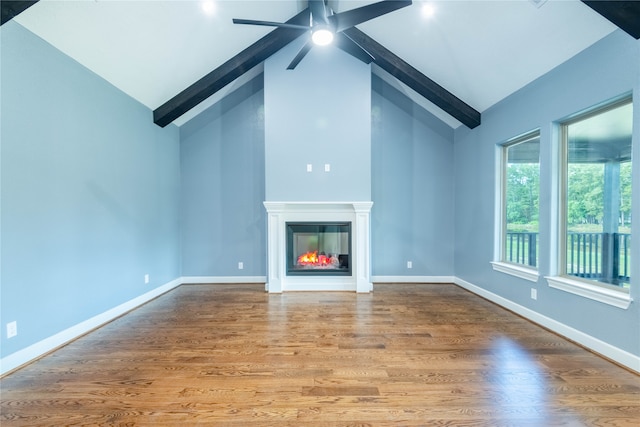 unfurnished living room featuring ceiling fan, hardwood / wood-style flooring, beam ceiling, and high vaulted ceiling