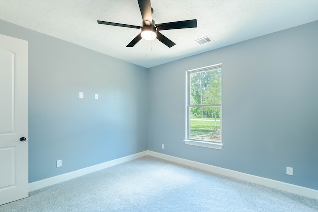 spare room featuring ceiling fan and carpet flooring