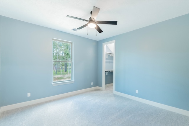 carpeted empty room featuring ceiling fan