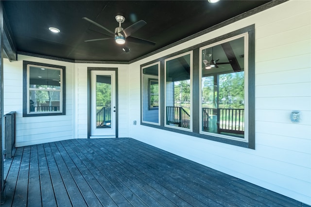 wooden deck featuring ceiling fan