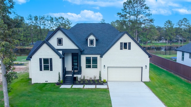 view of front of property with a garage and a front lawn