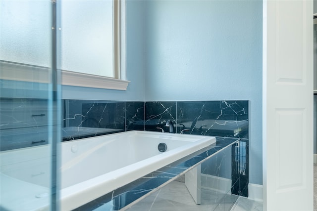 bathroom with tiled tub