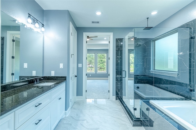 bathroom with ceiling fan, vanity, and separate shower and tub