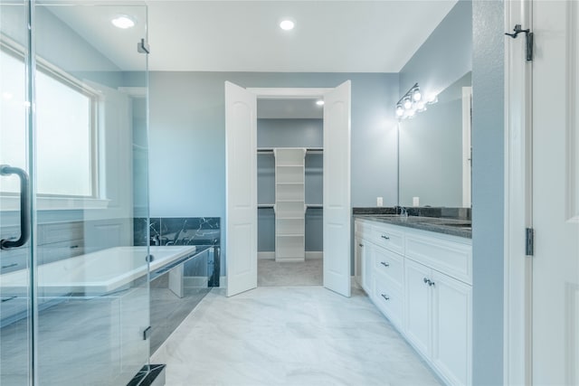 bathroom featuring shower with separate bathtub and vanity