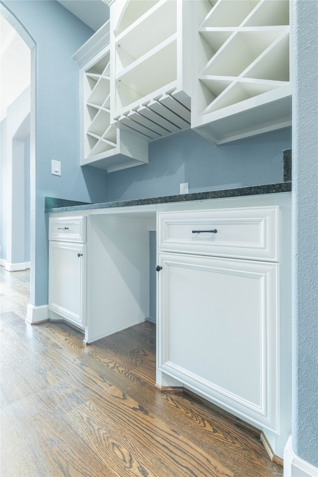 interior space with white cabinetry and dark hardwood / wood-style flooring