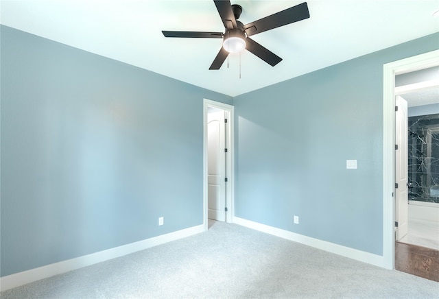 unfurnished bedroom with ensuite bath, ceiling fan, and carpet flooring