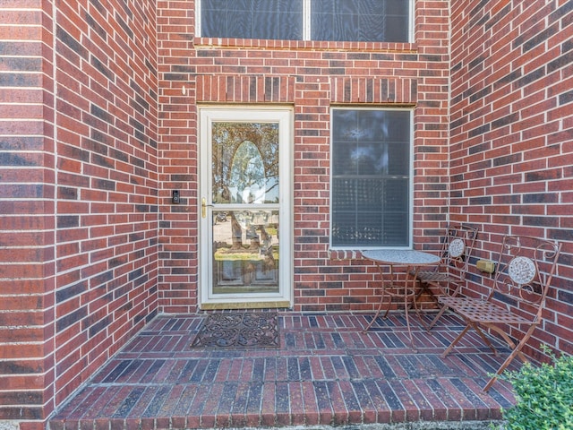 property entrance featuring a patio area