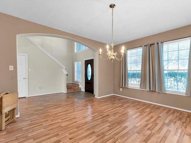 interior space featuring light hardwood / wood-style floors and a notable chandelier