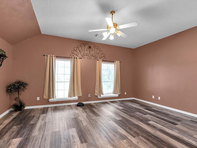 spare room with ceiling fan, lofted ceiling, and dark wood-type flooring