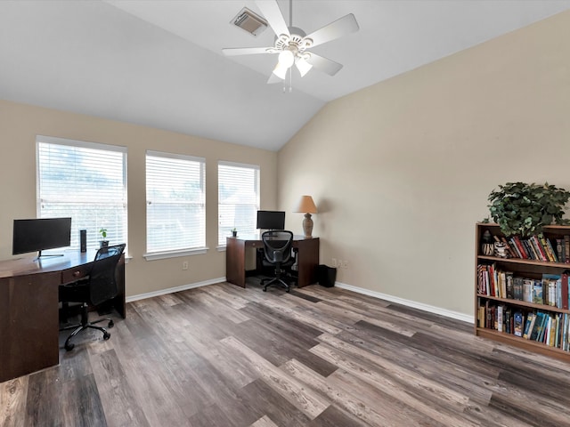 office featuring dark hardwood / wood-style floors, vaulted ceiling, ceiling fan, and a healthy amount of sunlight