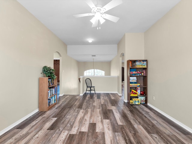 playroom with dark hardwood / wood-style flooring and ceiling fan