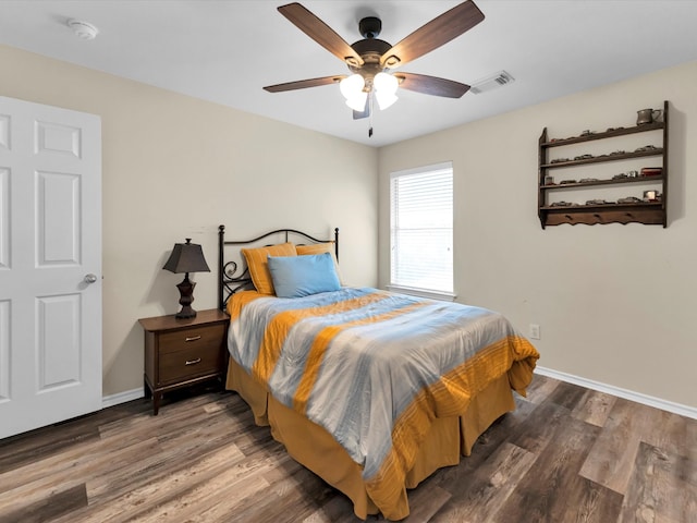 bedroom with ceiling fan and dark hardwood / wood-style floors