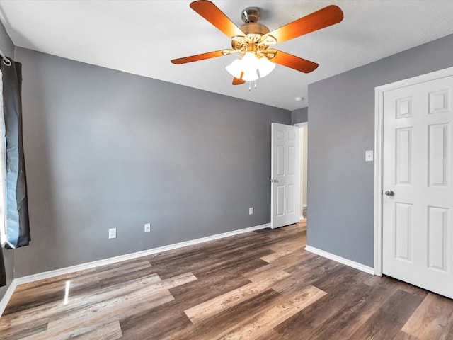 unfurnished bedroom featuring dark hardwood / wood-style floors and ceiling fan