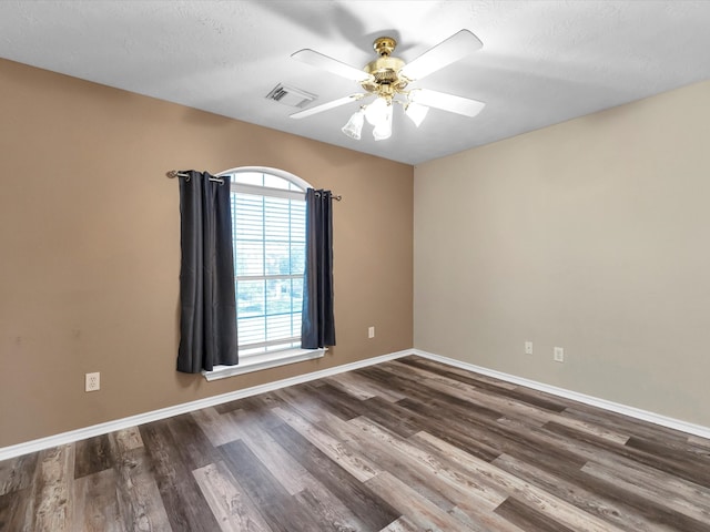 unfurnished room featuring a textured ceiling, ceiling fan, and dark wood-type flooring