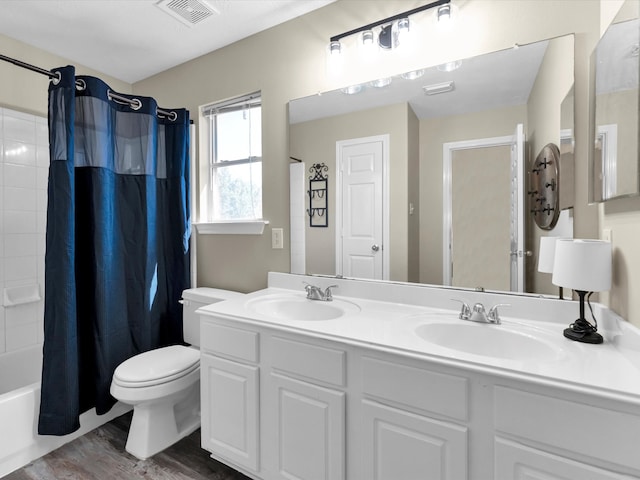 full bathroom with vanity, toilet, wood-type flooring, and shower / bath combo with shower curtain