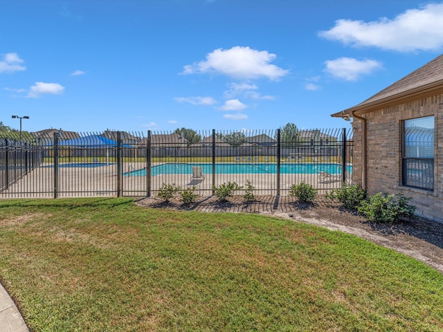 view of pool featuring a yard