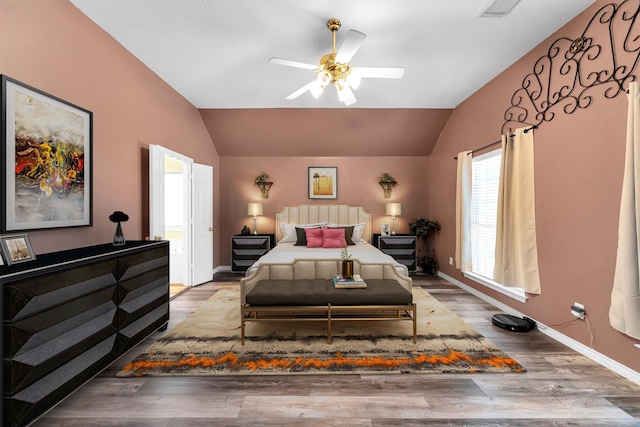 bedroom with hardwood / wood-style flooring, ceiling fan, and lofted ceiling