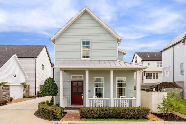 view of front of property featuring a porch and a garage