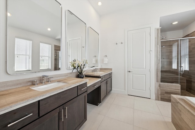 bathroom featuring tile patterned flooring, a shower with shower door, and vanity