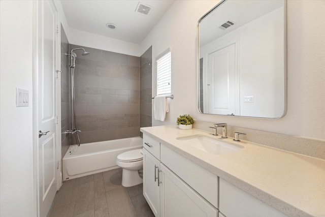 full bathroom with vanity, hardwood / wood-style flooring, tiled shower / bath, and toilet