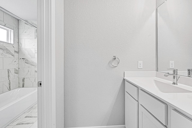 bathroom featuring tiled shower / bath combo and vanity