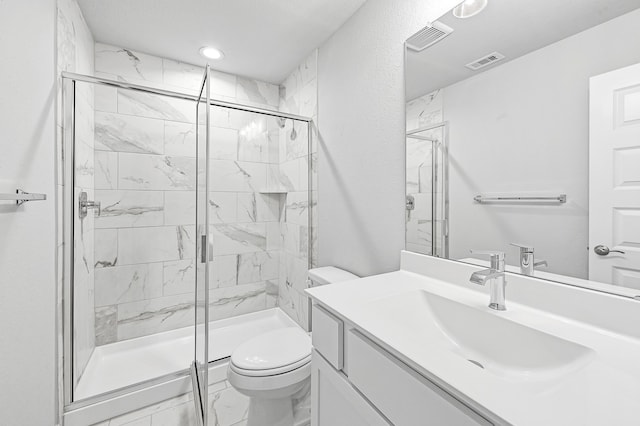 bathroom with a shower with shower door, vanity, and toilet