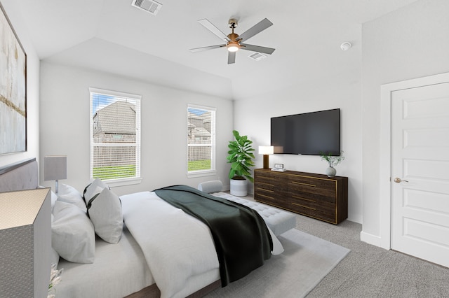 carpeted bedroom featuring ceiling fan, multiple windows, and lofted ceiling