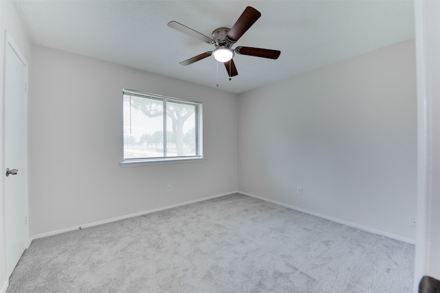 unfurnished room featuring ceiling fan and light colored carpet