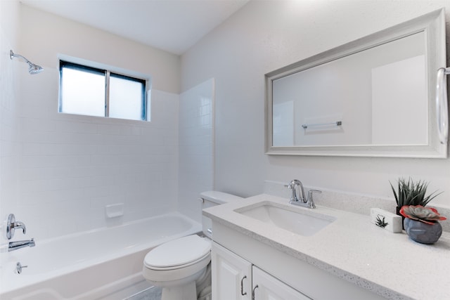 full bathroom with vanity, tiled shower / bath combo, and toilet