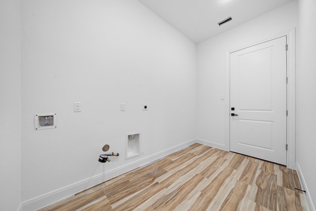 laundry room with hookup for a washing machine, light hardwood / wood-style flooring, hookup for a gas dryer, and electric dryer hookup