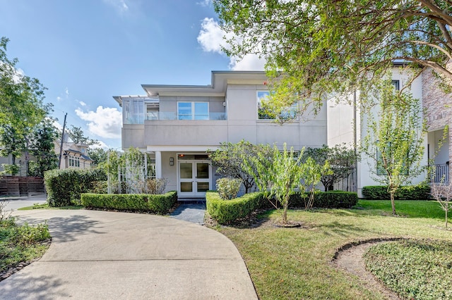 view of front of house with french doors and a front yard