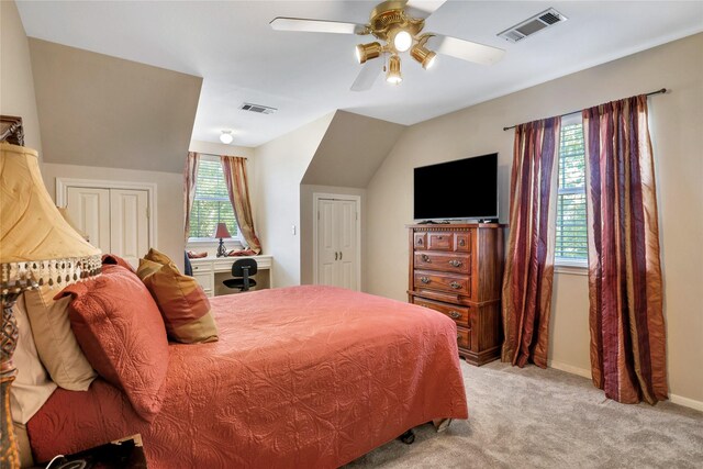 carpeted bedroom with ceiling fan and lofted ceiling