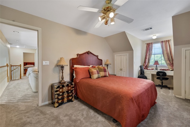 bedroom featuring light carpet, lofted ceiling, and ceiling fan