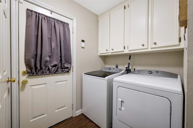 laundry area with cabinets, dark wood-type flooring, and separate washer and dryer