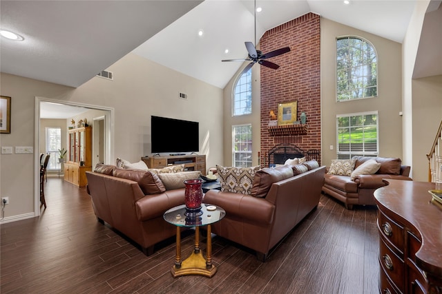 living room with dark hardwood / wood-style floors, ceiling fan, high vaulted ceiling, and a brick fireplace