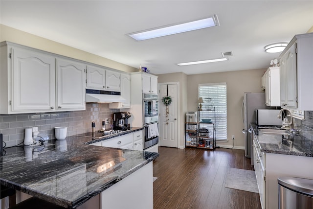 kitchen with backsplash, kitchen peninsula, white cabinetry, and dark hardwood / wood-style flooring